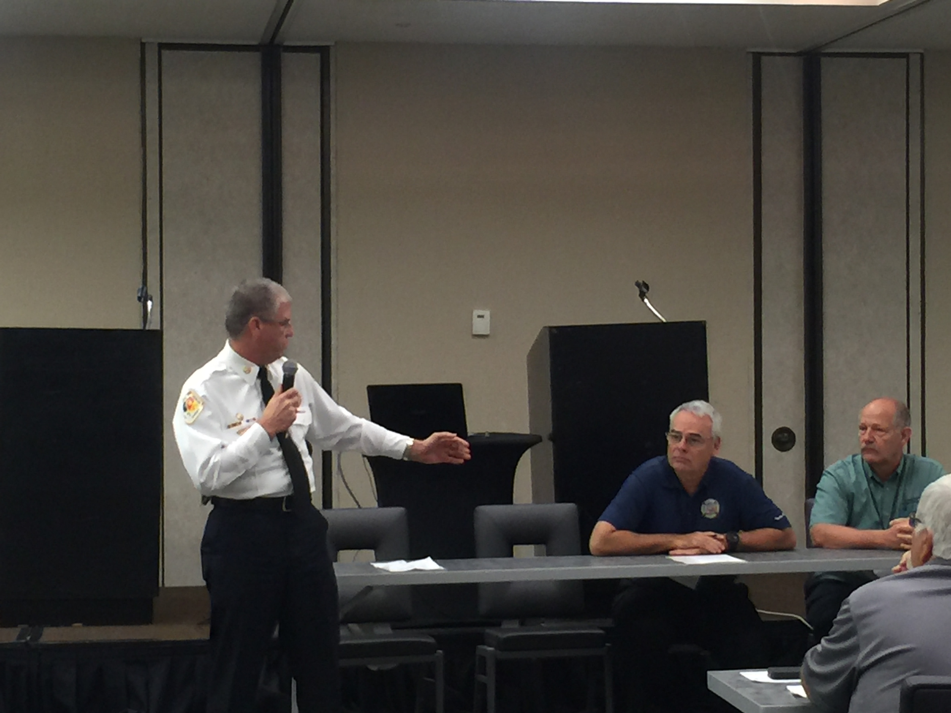 Todd LeDuc, (left to right) talks with Keith Tyson of the Firefighter Cancer Support Network and Rick Mason with the National Fallen Firefighters Foundation.