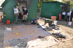 Alan Boyd, left, from the Wichita County, Texas Sheriff’s office, discusses the grid method of forensic analysis with Lucas Drago from Temple, Texas Fire Rescue. Kim Burris, Cleburne, Texas Police, and Bill Hollander, with the Bartlesville, Okla. Fire Department, sift through fire debris on a tarp, placing it on a location grid that mirrors the room they are investigating. Alan Boyd, left, from the Wichita County, Texas Sheriff’s office, discusses the grid method of forensic analysis with Lucas Drago from Temple, Texas Fire Rescue. Kim Burris, Cleburne, Texas Police, and Bill Hollander, with the Bartlesville, Okla. Fire Department, sift through fire debris on a tarp, placing it on a location grid that mirrors the room they are investigating.