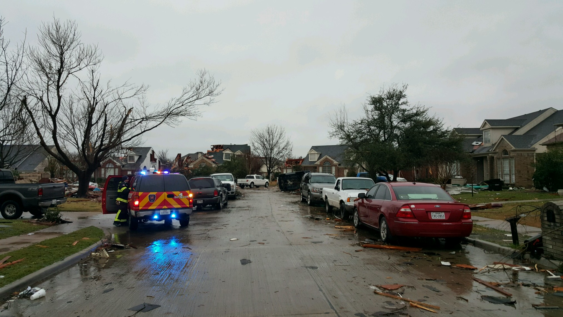 A Rowlett fire crew surveys a neighborhood following the tornado.