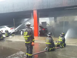 Firefighters work to control flames. Firefighters work to control flames.