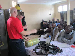Fishers, IN, Fire Department Fire Captain Todd Rielage and Cincinnati Fire Captain Matt Flagler begin a classroom session on SCBA during the Africa Fire Mission training in Nairobi, Kenya. Fishers, IN, Fire Department Fire Captain Todd Rielage and Cincinnati Fire Captain Matt Flagler begin a classroom session on SCBA during the Africa Fire Mission training in Nairobi, Kenya.