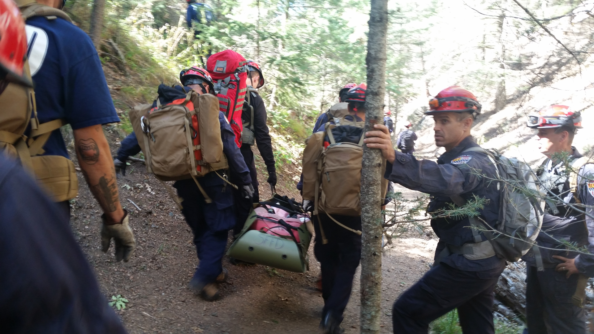 A Santa Fe (NM) Fire Department team trains using the Rapid Extraction Module (REM) in which a team of responders can extract a downed firefighter in a wildland setting.