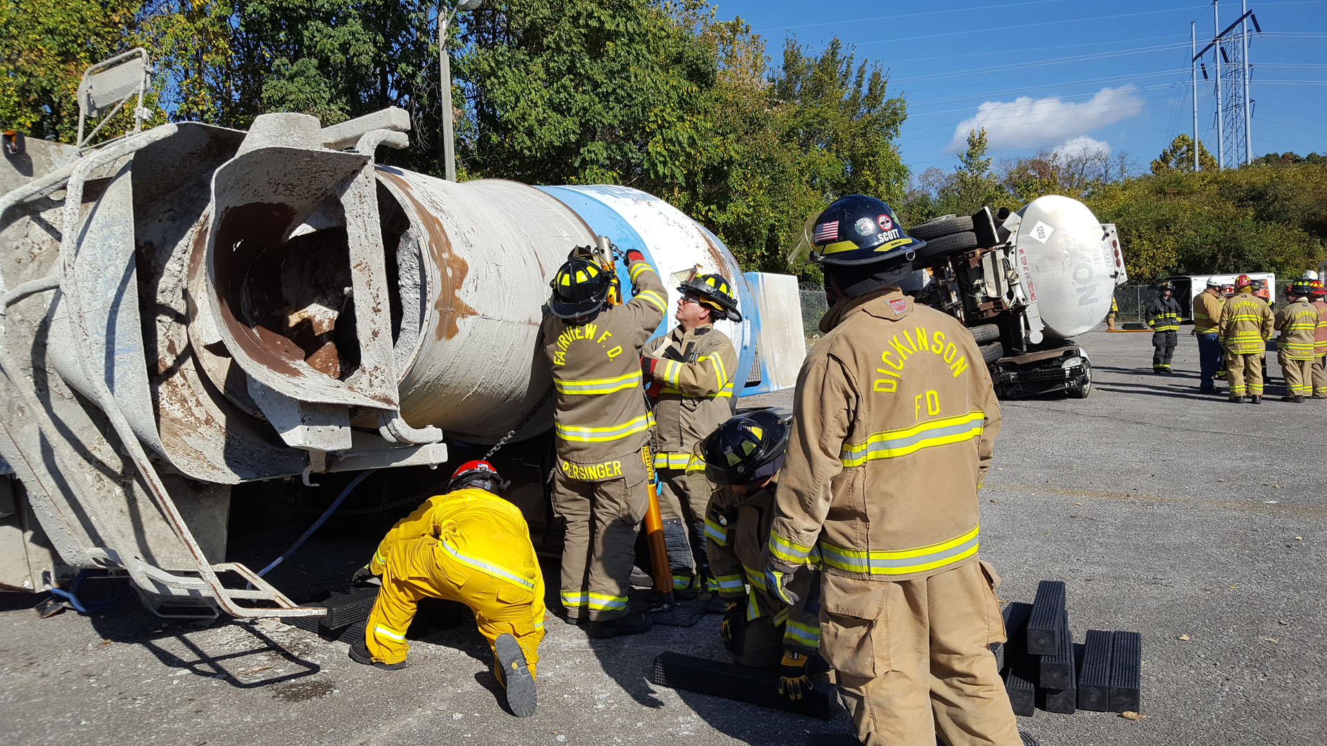 Students use techniques they learned during a big rig rescue class at Firehouse Expo to lift a cement truck off a Mustang convertible.