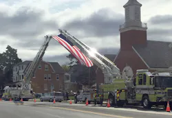 The Slatington ladder truck (left) was requested by a neighboring fire department to help fly an American flag at a funeral. The Slatington ladder truck (left) was requested by a neighboring fire department to help fly an American flag at a funeral.