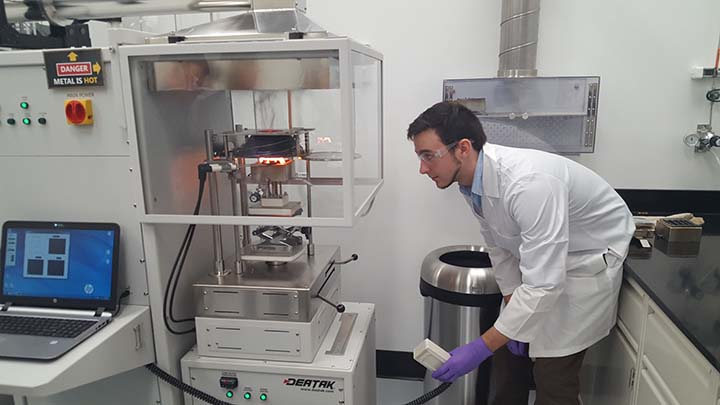 A Gore associate burns a portion of the company's Parallon liner system in a Cone Calorimeter to measure the fabric's heat-release characteristics. The fabric was subjected to about 1,700 degrees Fahrenheit in the device.