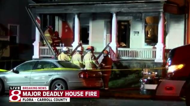 Firefighters at the scene of the deadly house fire in Flora.