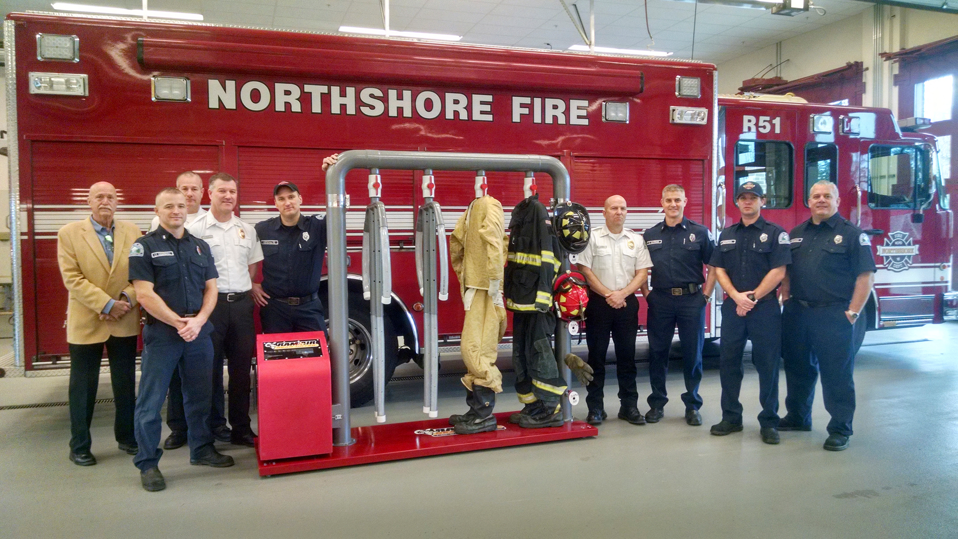 Ram Air Gear Dryer Director of Sales David Adams (left) presents a Ram Air 4-MU Gear Dryer from the Hometown Heroes contest to Northshore Fire Department staff in Kenmore, WA.