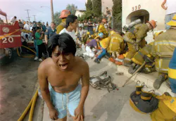 A young man weeps in May 1993 after seeing a dead child in front of an apartment house devastated by a fire in the Westlake district of Los Angeles, Calif. Los Angeles police have announced the arrests of three people in connection with the fire. A young man weeps in May 1993 after seeing a dead child in front of an apartment house devastated by a fire in the Westlake district of Los Angeles, Calif. Los Angeles police have announced the arrests of three people in connection with the fire.