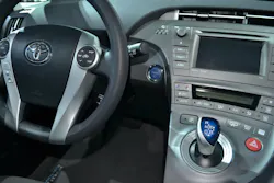This 2015 Toyota Prius has a keyless ignition start/stop push button, an electronic parking brake button on the center console, and a joystick-type gear selector. This 2015 Toyota Prius has a keyless ignition start/stop push button, an electronic parking brake button on the center console, and a joystick-type gear selector.