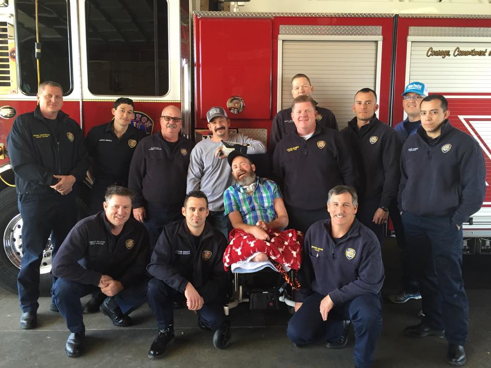 Houston firefighters surround Capt. Bill 'Iron' Dowling for a group photo last year.