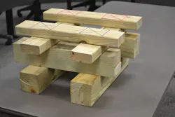 Markings on the top layer of this training cribbing indicate the 12 1/4 square inches of load-bearing contact at each of the four points on this 2 x 4 and 4 x 4 double-box crib. Multiplying 12 1/4 x 500 psi gives this soft wood box crib its 24,500-pound capacity when all four contact points are evenly loaded. Each wood piece is positioned so the load is applied perpendicular or in a cross-grain fashion. Also note the 3 1/2-inch end “overhang” of each layer in the stack. Photo by Ron Moore Markings on the top layer of this training cribbing indicate the 12 1/4 square inches of load-bearing contact at each of the four points on this 2 x 4 and 4 x 4 double-box crib. Multiplying 12 1/4 x 500 psi gives this soft wood box crib its 24,500-pound capacity when all four contact points are evenly loaded. Each wood piece is positioned so the load is applied perpendicular or in a cross-grain fashion. Also note the 3 1/2-inch end “overhang” of each layer in the stack. Photo by Ron Moore