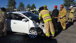 A team of firefighters work on a late model Nissan sedan to disconnect 12-volt power before a simulated rescue begins during the University of Extrication during Firehouse Expo in Nashville. A team of firefighters work on a late model Nissan sedan to disconnect 12-volt power before a simulated rescue begins during the University of Extrication during Firehouse Expo in Nashville.
