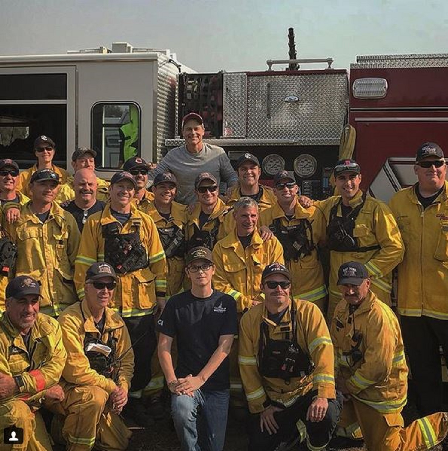Actor Rob Lowe poses with firefighters battling the Thomas Fire in Ventura and Santa Barbara counties after thanking them with a home-cooked meal.