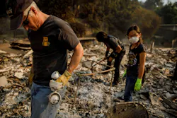 Jeff Lipscomb, from left, Gabriel Lipscomb, 17, and Rachel Lipscomb, 11, look for items to recover in the wreckage of their burned home on Dec. 6, 2017, in Ventura, CA. Jeff Lipscomb, from left, Gabriel Lipscomb, 17, and Rachel Lipscomb, 11, look for items to recover in the wreckage of their burned home on Dec. 6, 2017, in Ventura, CA.
