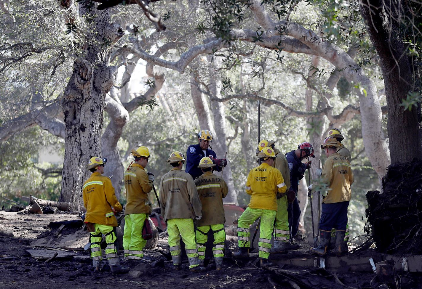 Firefighters prepare to search for the missing after a mudslide along Hot Springs Road in Montecito, CA, on Saturday, Jan. 13, 2018.