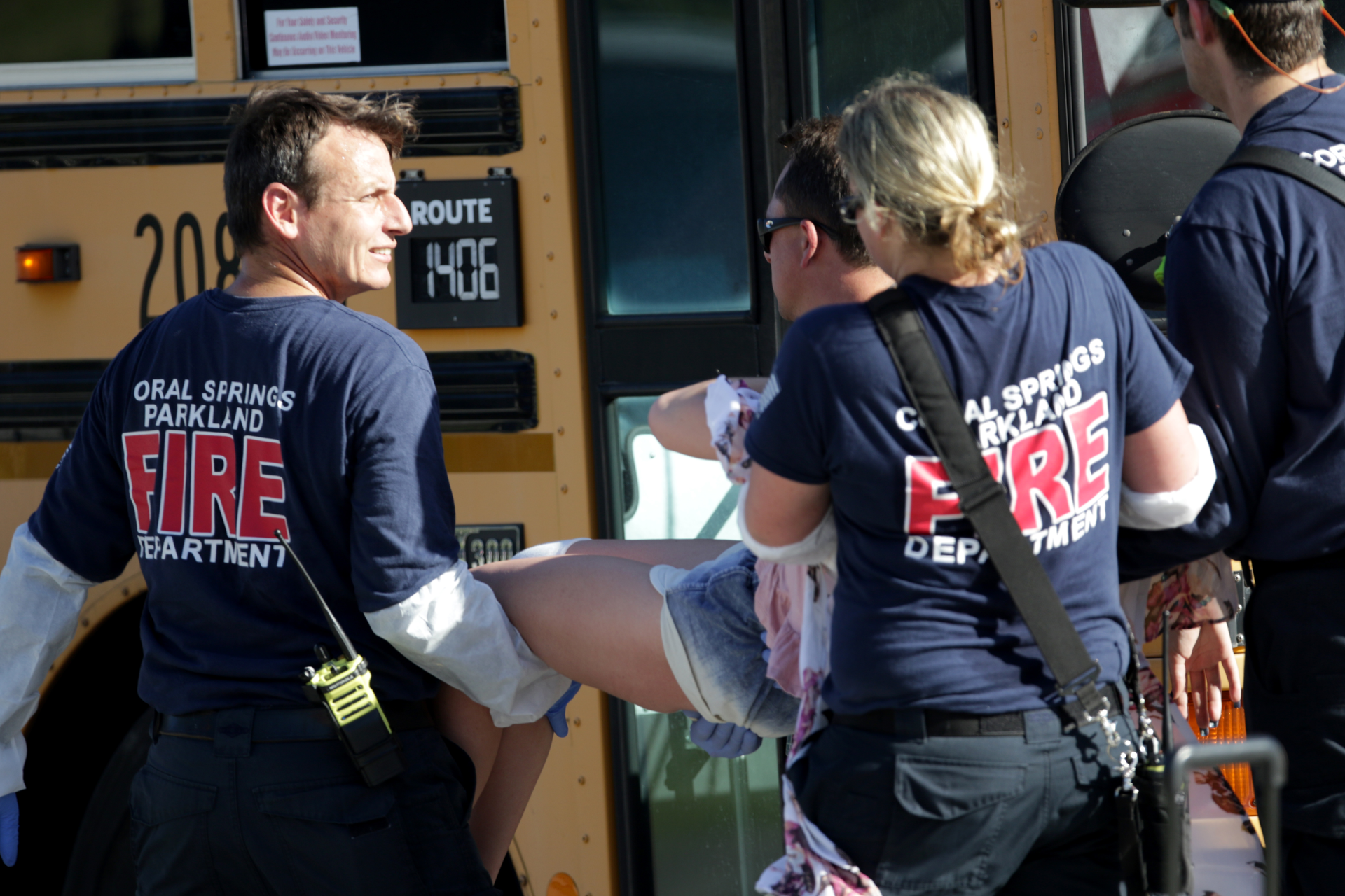 Medical personnel tend to a victim outside of Stoneman Douglas High School in Parkland, Fla., after a shooting on Wednesday, Feb. 14, 2018.