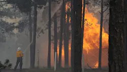 A firefighter fights a blaze in a detached garage in the Black Forest, CO, area on June 12, 2013. A firefighter fights a blaze in a detached garage in the Black Forest, CO, area on June 12, 2013.