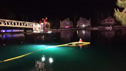 Las Vegas firefighters extend a bucket over a lake in a housing development to pull two people to safety after their car crashed into the water on Tuesday, April 17, 2018. Las Vegas firefighters extend a bucket over a lake in a housing development to pull two people to safety after their car crashed into the water on Tuesday, April 17, 2018.