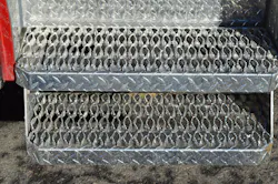 This step arrangement provides a lower step for entrance into the cab. Be careful that the location of any cab- or chassis-mounted components ahead of the front axle do not reduce the angle of approach and become a hazard when operating in tight locations. This step arrangement provides a lower step for entrance into the cab. Be careful that the location of any cab- or chassis-mounted components ahead of the front axle do not reduce the angle of approach and become a hazard when operating in tight locations.