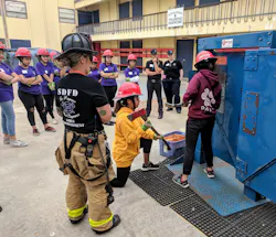 Teens participate in a forcible-entry drill at the Girls Empowerment Camp. Teens participate in a forcible-entry drill at the Girls Empowerment Camp.
