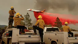 Firefighters watch a plane drop flame retardant on the Ferguson Fire in the Stanislaus National Forest on Sunday, July 22, 2018. Firefighters watch a plane drop flame retardant on the Ferguson Fire in the Stanislaus National Forest on Sunday, July 22, 2018.