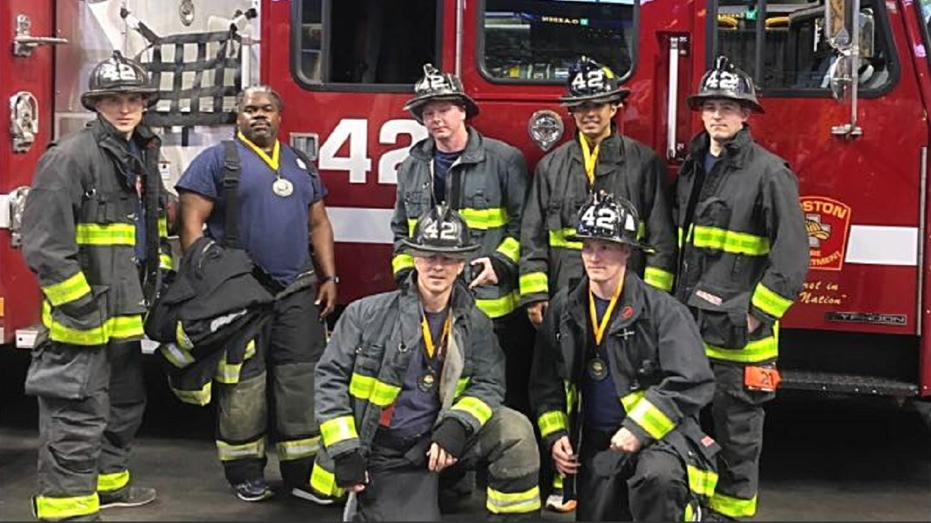 Boston firefighter Justin Poitras, standing second from right, with fellow members of Engine 42 in January 2018.