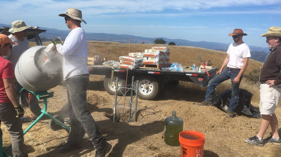 A construction crew works on installation of a tower in Sonoma County, CA, that will house a high-definition camera as part of a wide network designed to monitor wildfire activity.