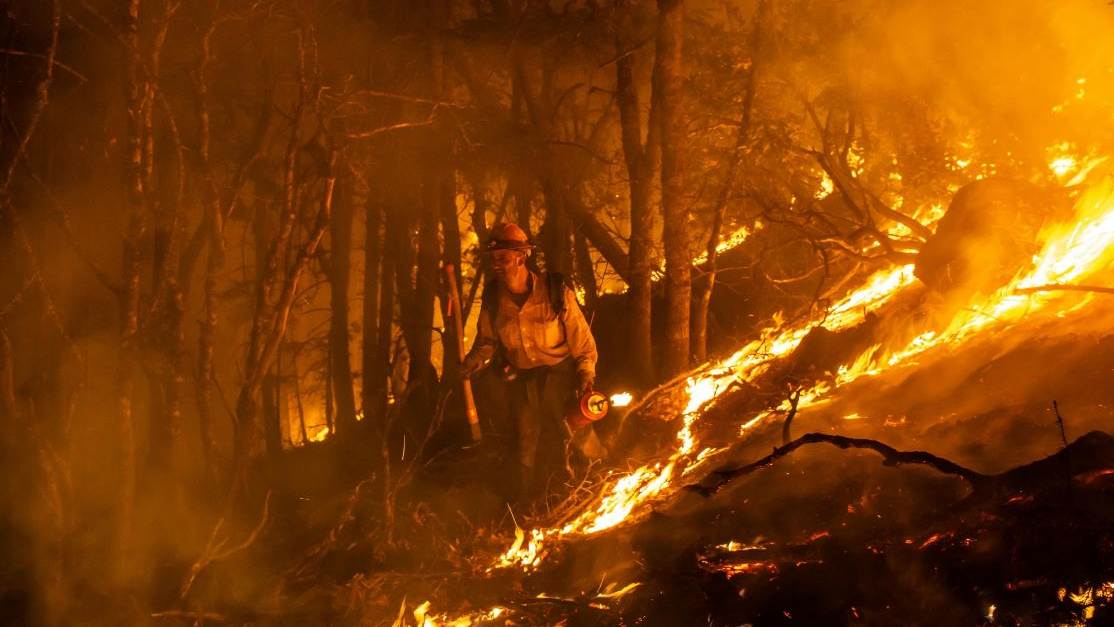 A firefighter monitors a burn operation near the town of Ladoga, CA, on Aug. 7, 2018.