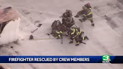 Sacramento firefighters pull a colleague to safety after he began to fall through the roof of a commercial building during a fire on Wednesday, Oct. 24, 2018. Sacramento firefighters pull a colleague to safety after he began to fall through the roof of a commercial building during a fire on Wednesday, Oct. 24, 2018.