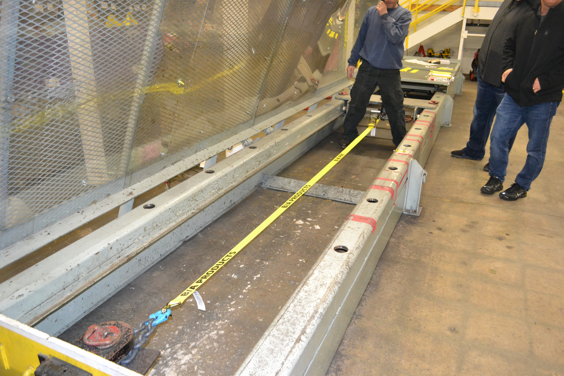 A ratchet unit with 2-inch-wide webbing is placed in a test bed and prepared for the Standard Hand Force test. Photos by Ron Moore