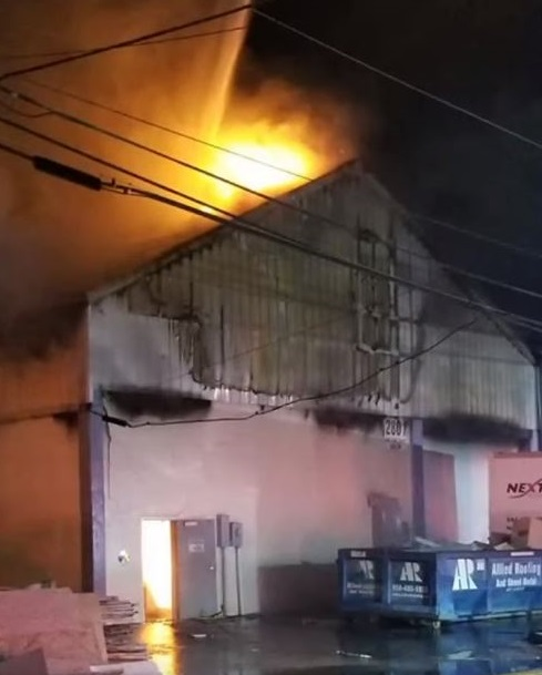 Nearly 40 firefighters from nine departments battled a three-alarm warehouse blaze Wednesday night in Tamarac, FL.