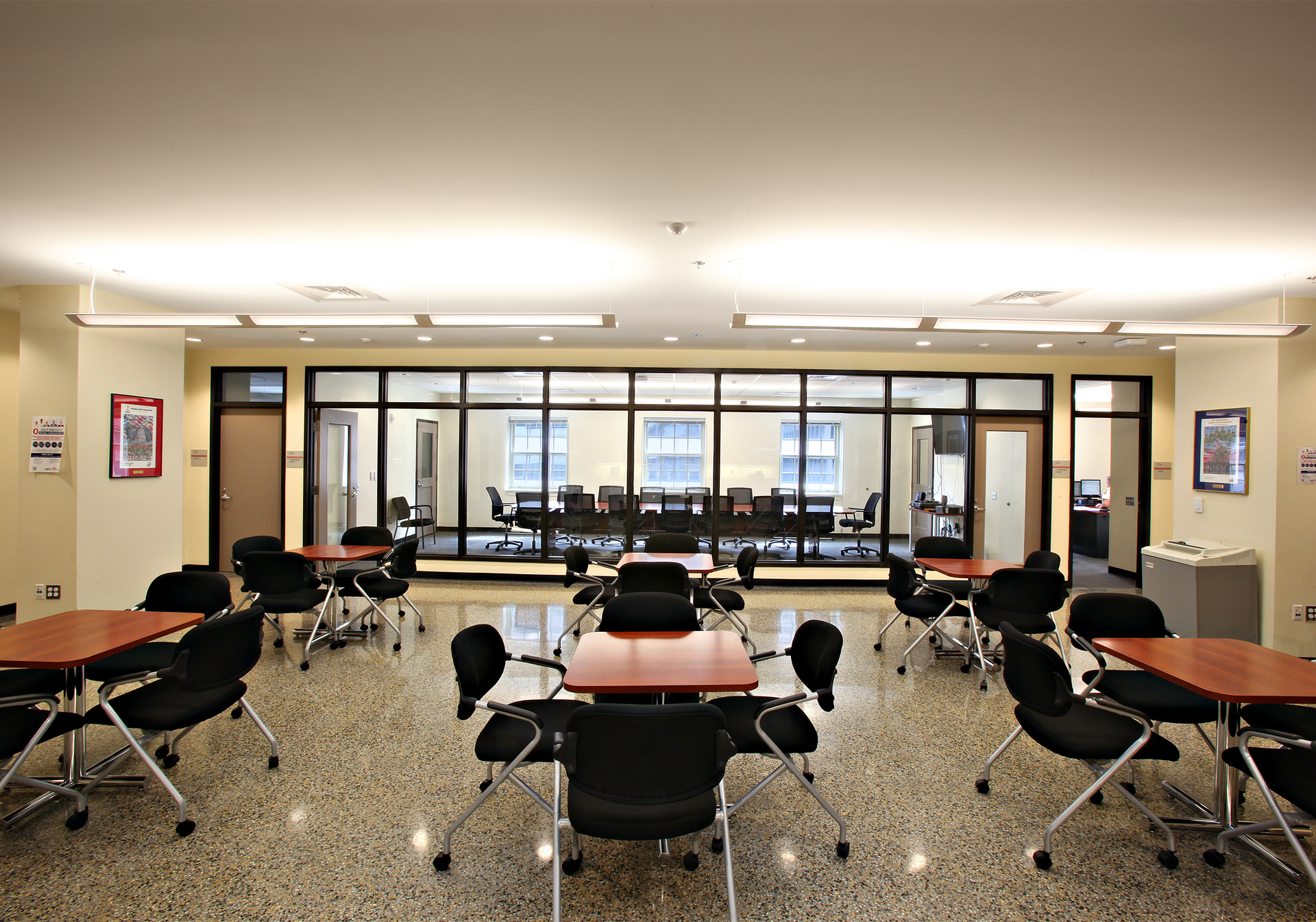 The renovated District of Columbia Engine Co. 16 features a training conference center that has wood cabinets and furniture, a renovated skylight, and interior glass panels that allow views through adjacent spaces to the outside. This strategy also allows daylight to penetrate deeply inside the building to create an uplifting work environment.
