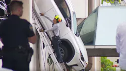 Firefighters rescued a driver from an SUV that was dangling from a parking garage Thursday in Miami Springs. Firefighters rescued a driver from an SUV that was dangling from a parking garage Thursday in Miami Springs.