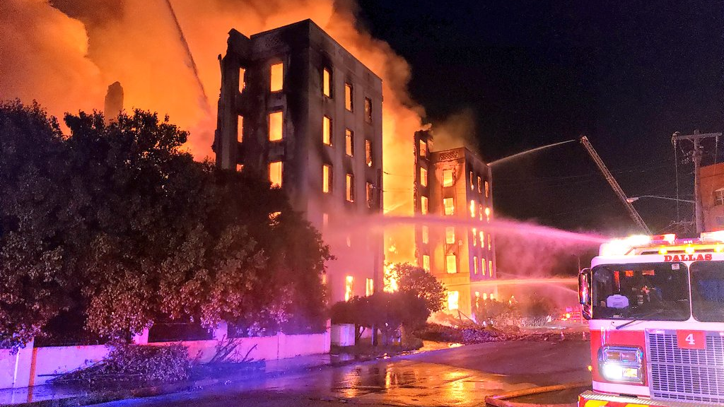 More than 100 Dallas firefighters battled a four-alarm blaze at the vacant Ambassador Hotel near the city's downtown.