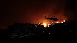 A helicopter battles the Woolsey fire in the hills above Pepperdine University in Malibu, CA, on Nov. 9, 2018. A helicopter battles the Woolsey fire in the hills above Pepperdine University in Malibu, CA, on Nov. 9, 2018.