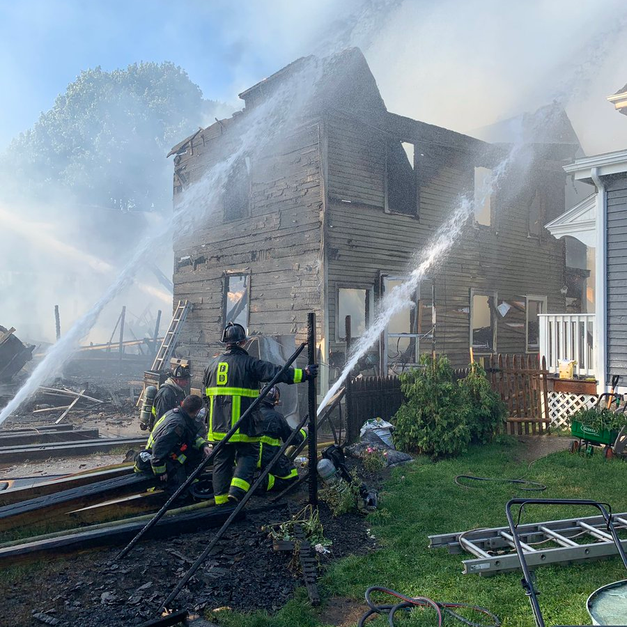 Seven Boston firefighters were hurt battling a nine-alarm blaze that spread to eight homes in the Mattapan neighborhood Saturday.