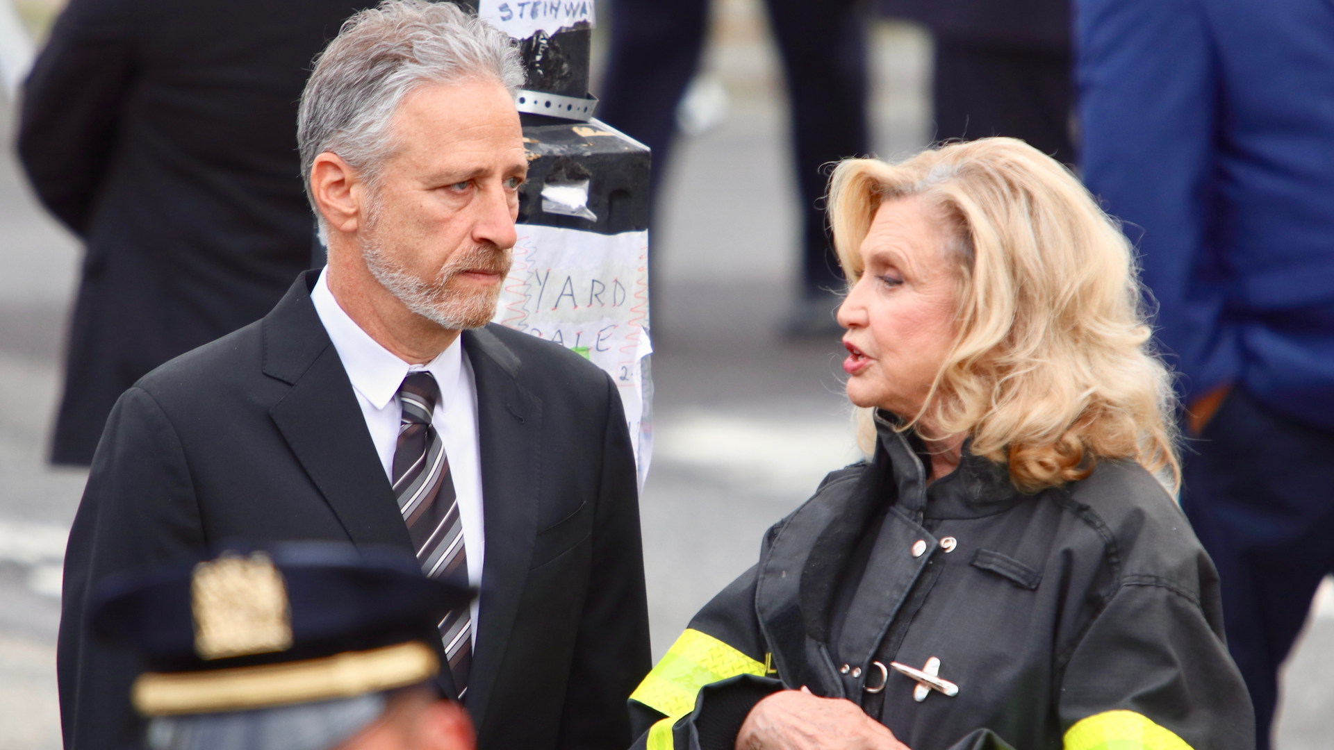 Former 'Daily Show' host and 9/11 advocate John Stewart and U.S. Rep. Carolyn Maloney attend the funeral of Ground Zero first responder Det. Luis Alvarez on July 3 in New York City.