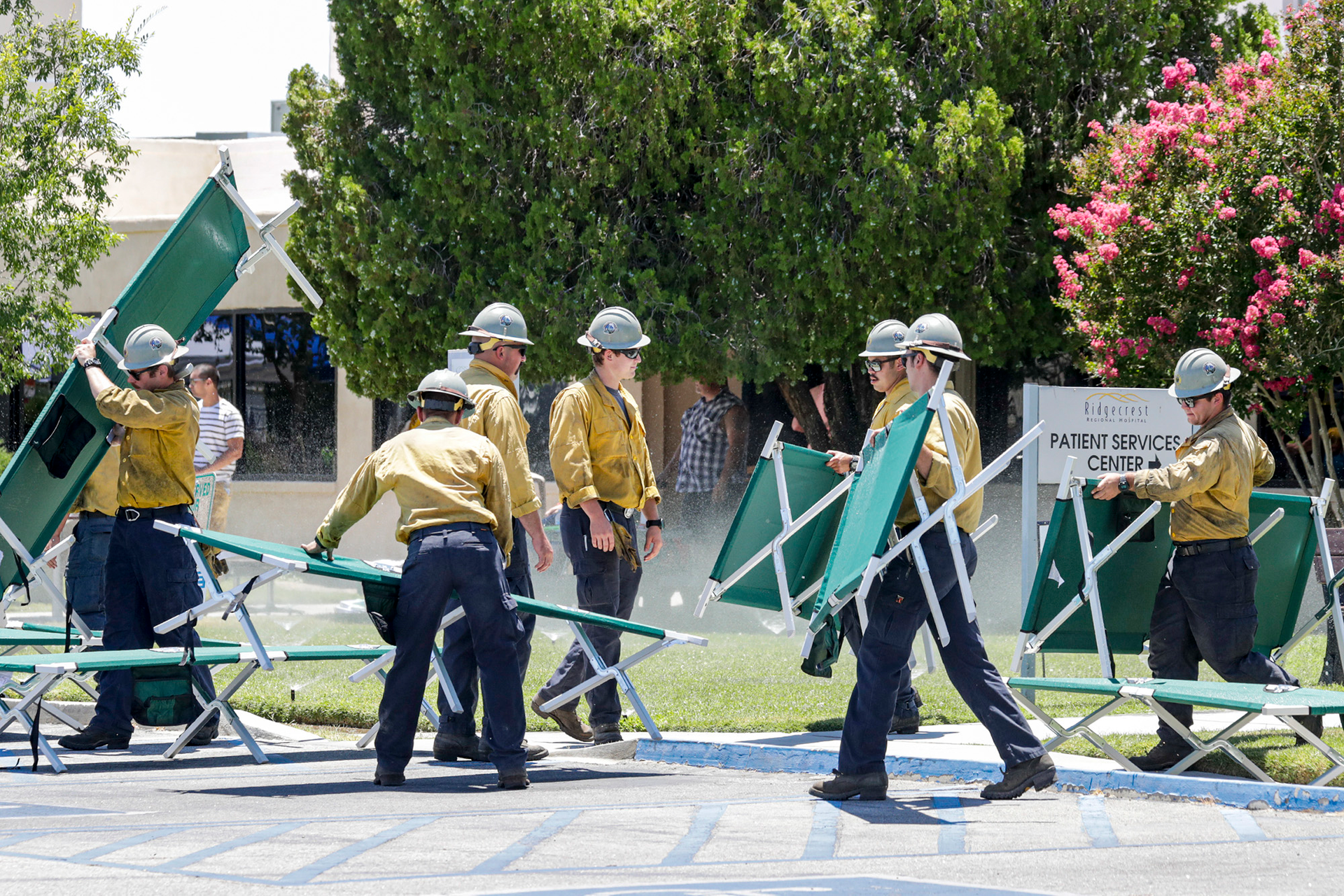 Firefighters place cots for patients that are being evacuated from Ridgecrest Regional Hospital after Ridgecrest, CA, was hit by a 6.4 earthquake on Thursday, July 4, 2019.