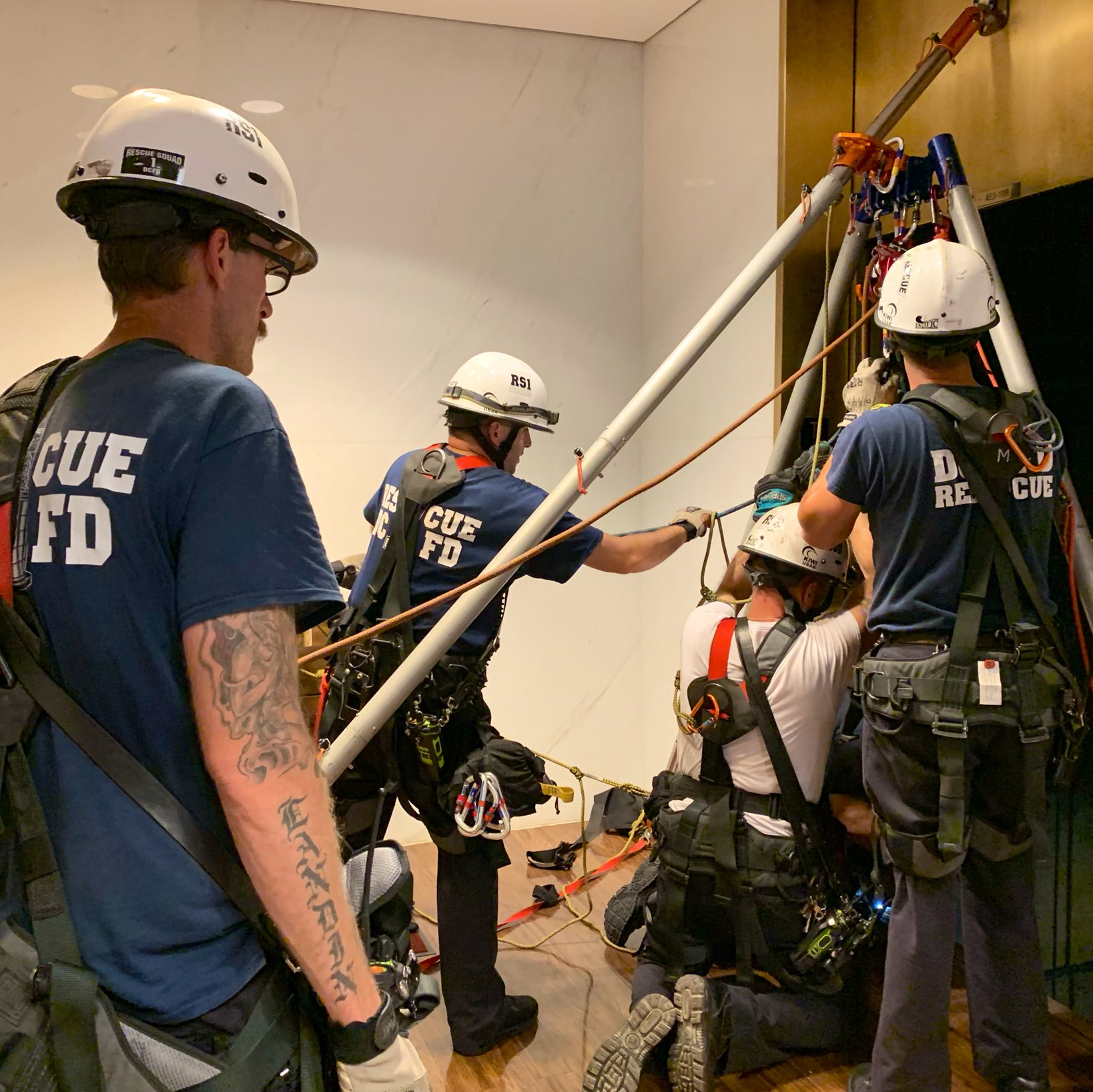 District of Columbia firefighters rescue two adults and a child from a stalled elevator at the Kennedy Center on Sunday.