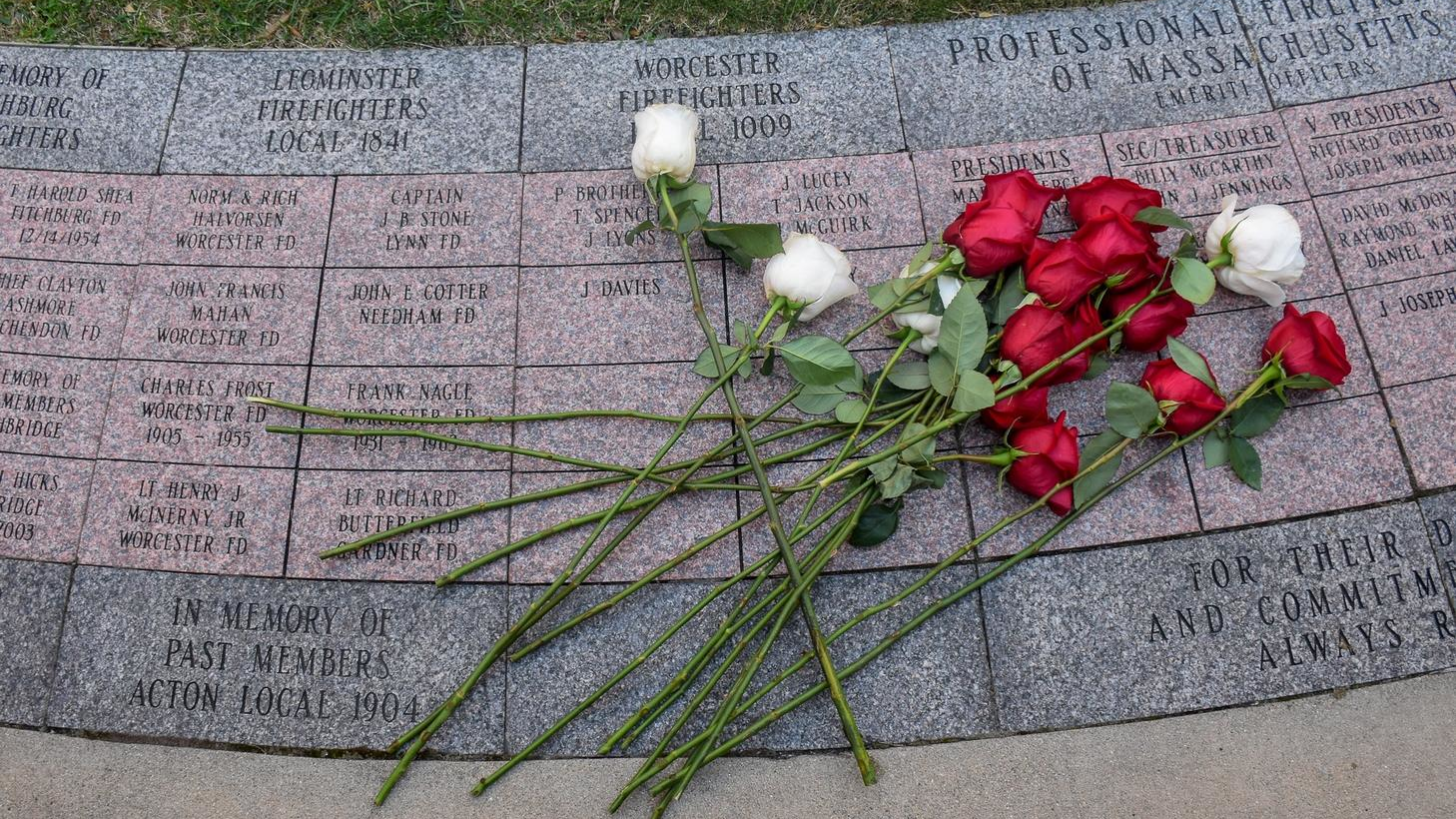 Roses from Firefighter Christopher Roy's family lay on a stone bearing his name at the Massachusetts Fallen Firefighters Memorial in Boston on Wednesday.