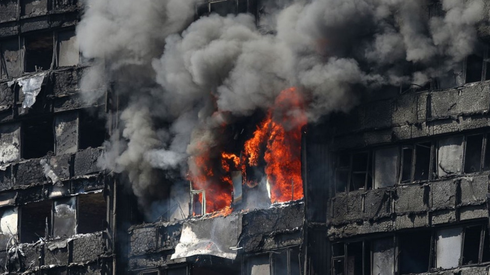 Smoke billows from the 24-story Grenfell Tower in west London on June 14, 2017, during a fire that killed 72 people.