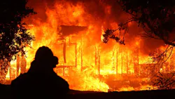 A firefighter stands in the foreground while a home burns as the Kincade Fire moves through Geyserville, CA on Oct. 24, 2019. A firefighter stands in the foreground while a home burns as the Kincade Fire moves through Geyserville, CA on Oct. 24, 2019.