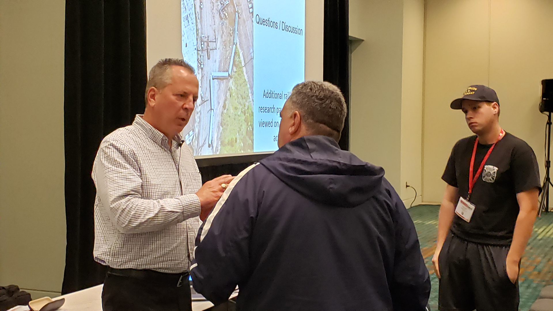 Philadephia Battalion Chief Vincent Mulray, left, speaks with firefighters who attended his class on an Amtrak train wreck at Firehouse Expo in Nashville.
