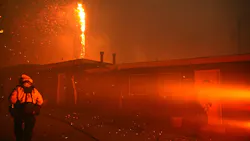 Firefighters walk near homes that are threatened by the Woolsey fire in Malibu, CA. Firefighters walk near homes that are threatened by the Woolsey fire in Malibu, CA.