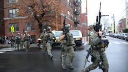 Police arrive at the scene of an active shooting Tuesday in Jersey City, NJ. One officer was fatally shot when a couple carrying long rifles opened fire. Police arrive at the scene of an active shooting Tuesday in Jersey City, NJ. One officer was fatally shot when a couple carrying long rifles opened fire.