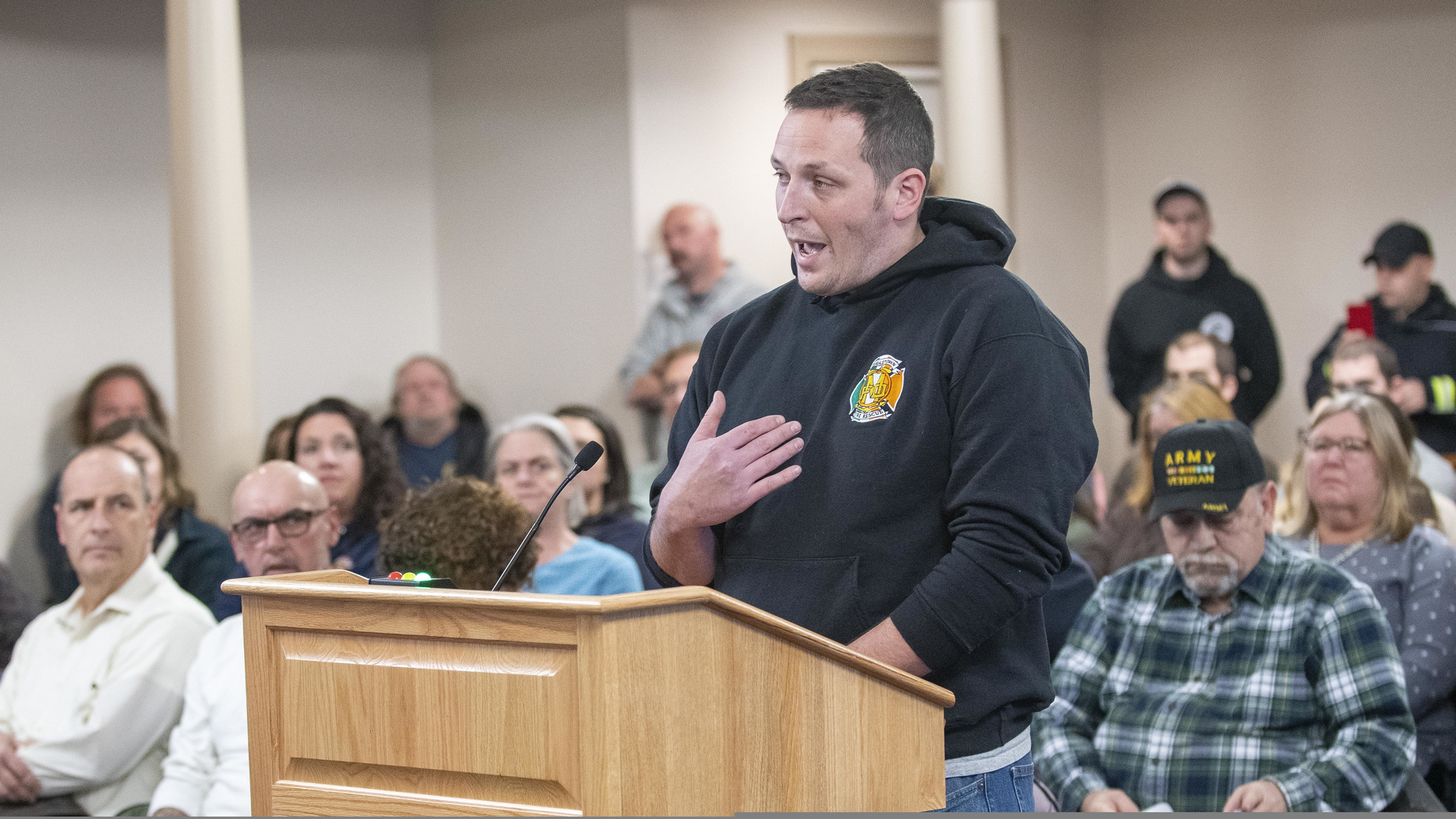 Middletown, RI, firefighter John Jordan, who heads the town's fire union, addresses the Middletown Town Council on Monday.