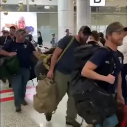 U.S. firefighters are welcomed with applause after landing in Sydney on Thursday. The group is part of about 100 firefighters who will be helping to battle the devastating wildfires raging across Australia. U.S. firefighters are welcomed with applause after landing in Sydney on Thursday. The group is part of about 100 firefighters who will be helping to battle the devastating wildfires raging across Australia.