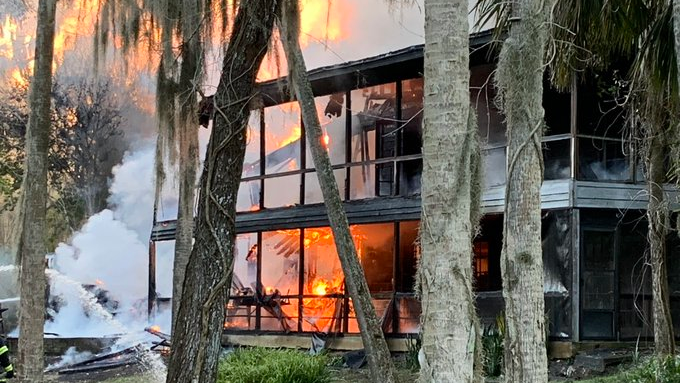 Firefighters from multiple departments kept at a safe distance as ammunition went off while they doused a burning house with water Sunday.