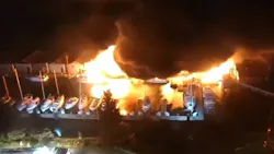 Multiple boats were engulfed in flames after a fire broke out at a marina under the West Seattle Bridge late Friday. Multiple boats were engulfed in flames after a fire broke out at a marina under the West Seattle Bridge late Friday.