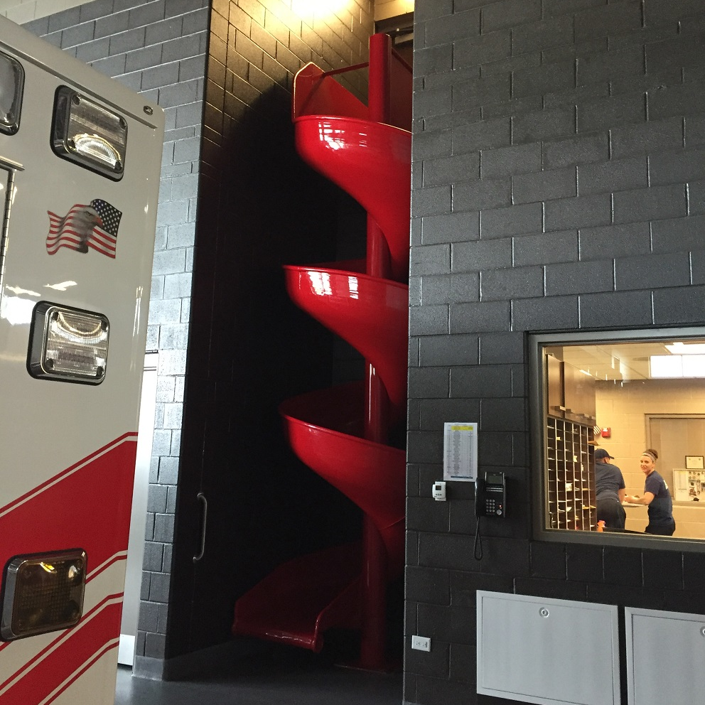 A non-traditional slide for firefighters to quickly descend from the second floor to the apparatus bay.